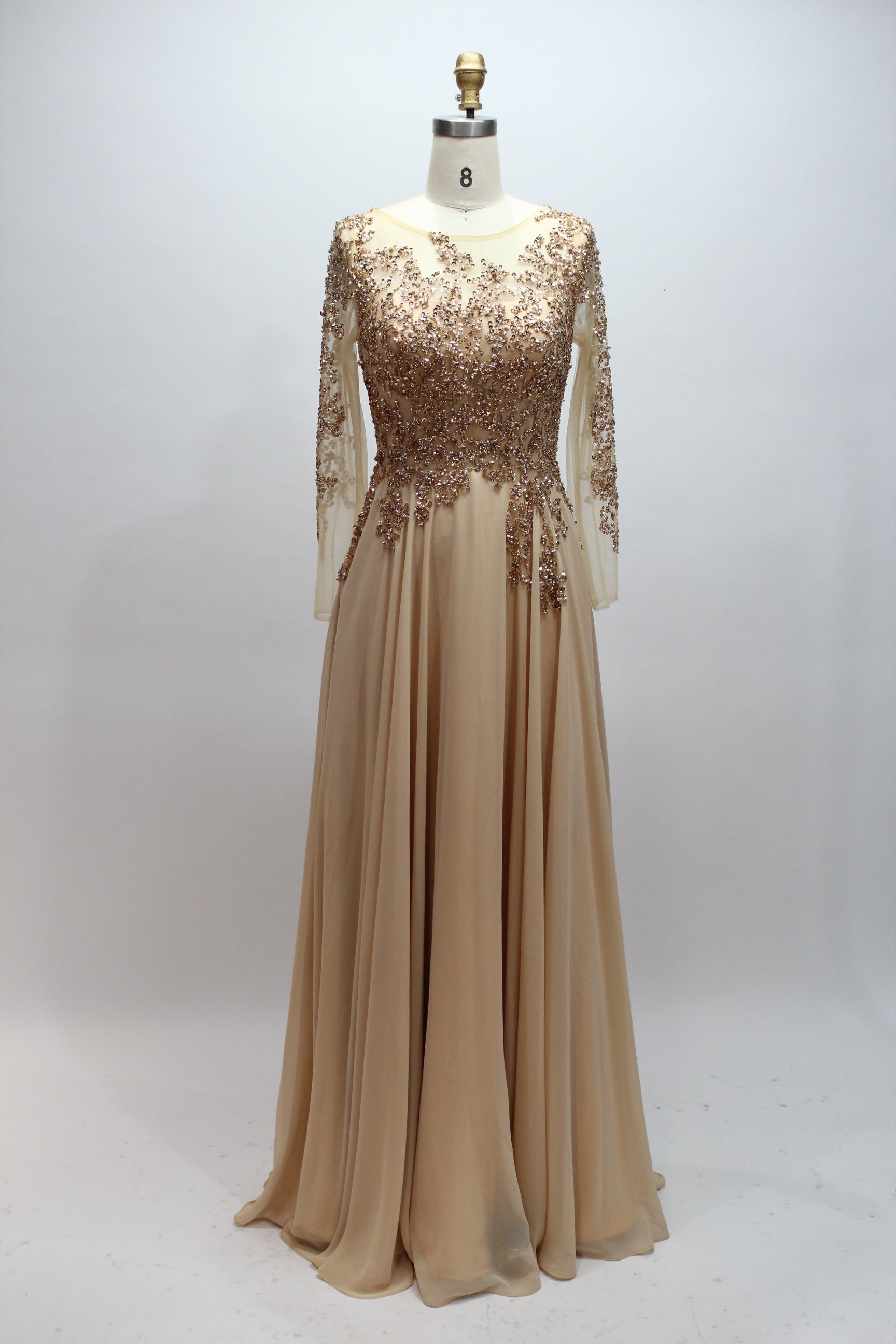 Elegant champagne-gold mother of the bride dress featuring a scoop neck, sheer long sleeves with sequin embroideries, and a flowing long A-line chiffon skirt.