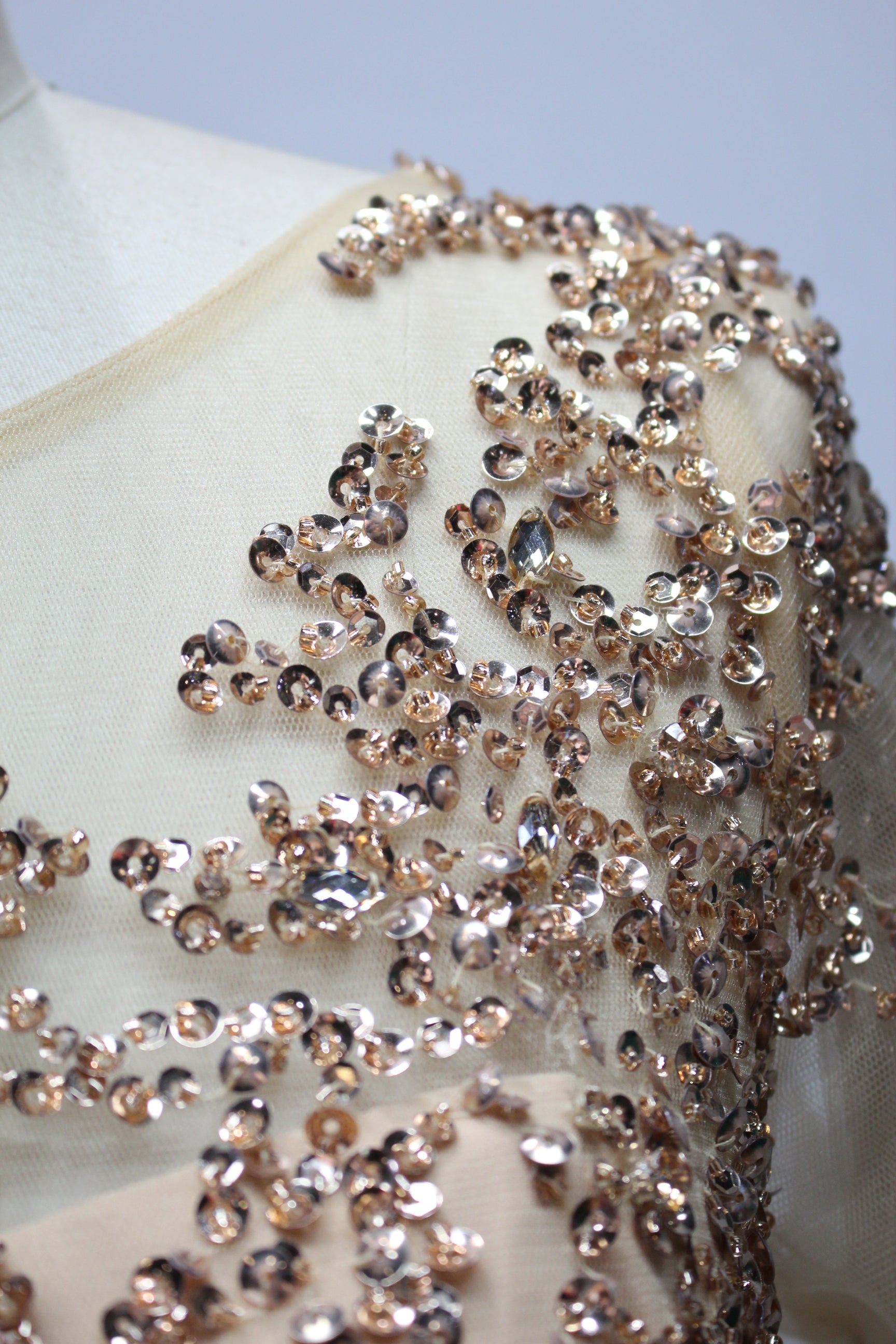 Elegant champagne-gold mother of the bride dress featuring a scoop neck, sheer long sleeves with sequin embroideries, and a flowing long A-line chiffon skirt.