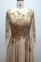 Champagne sequin lace fitted dress with long sheer sleeves and beaded waist detail
