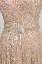 Close-up of champagne sequin V-neck bodice with draped beading and waist detail