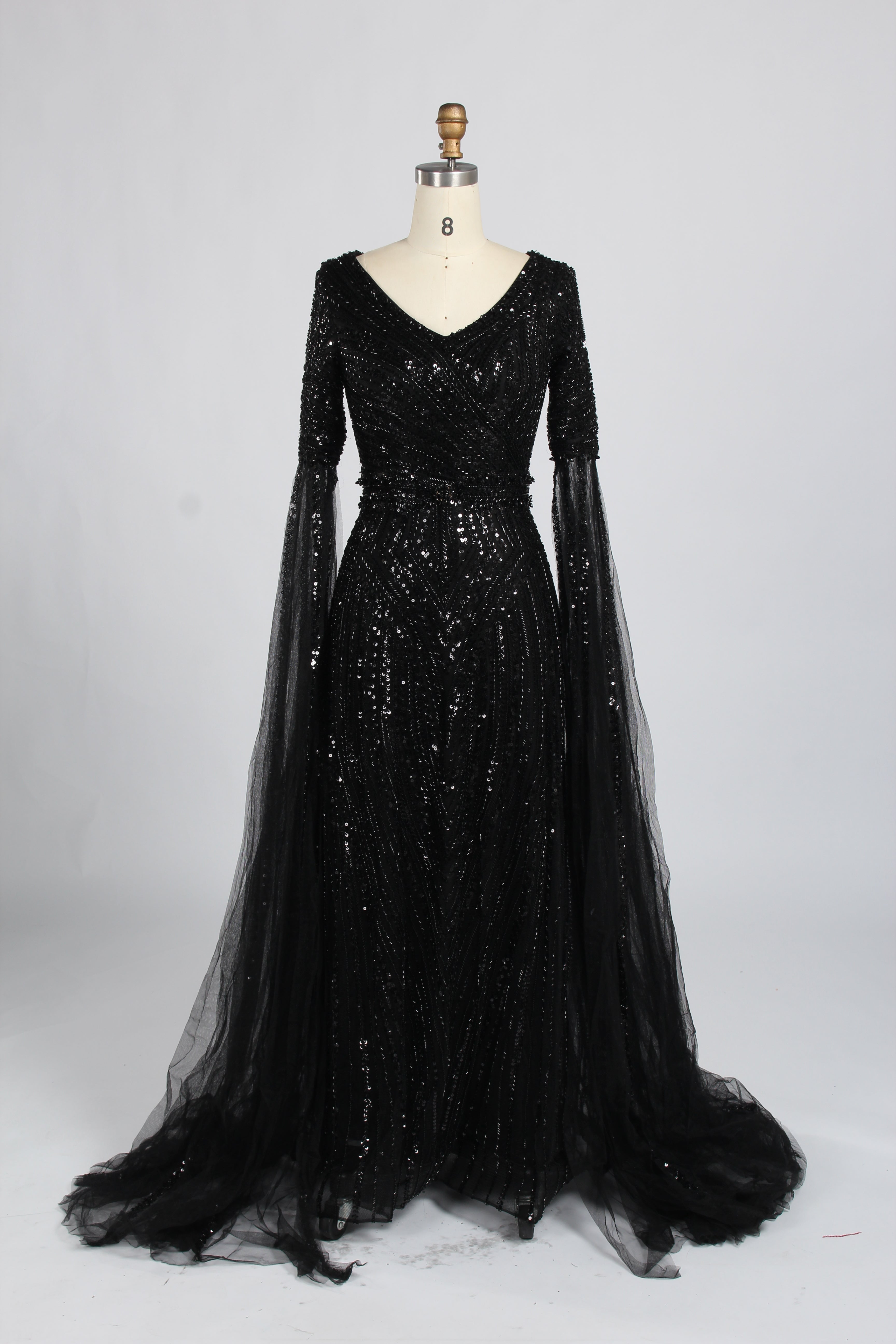 Black sequin V-neck evening gown with long sheer cape sleeves and A-line tulle skirt