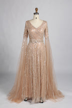 Champagne gold sequin V-neck evening gown with sheer cape sleeves and A-line skirt