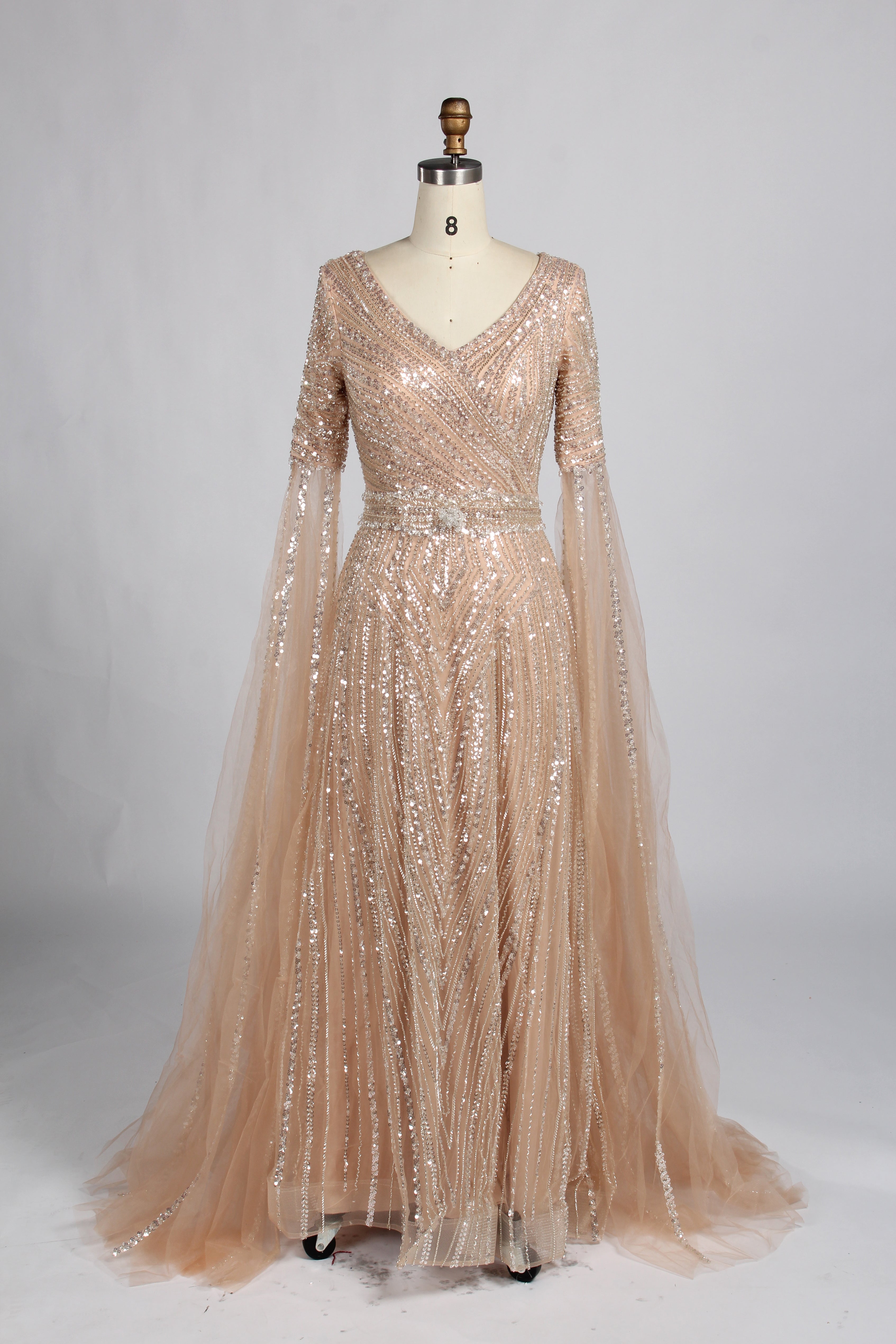 Champagne gold sequin V-neck evening gown with sheer cape sleeves and A-line skirt